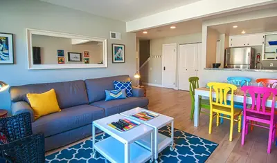 a living room with a couch and a table and chairs at Love Bug by Funtierland Vacation Rentals in Anaheim