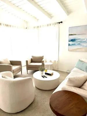 a living room with white furniture and a coffee table at Steps to Sand Cozy 3BR Partial Ocean Views in Manhattan Beach