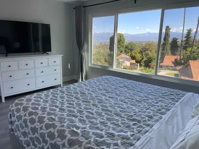 a bedroom with a bed and a large window at 5 Bedroom House with fabulous mountain views in Hacienda Heights