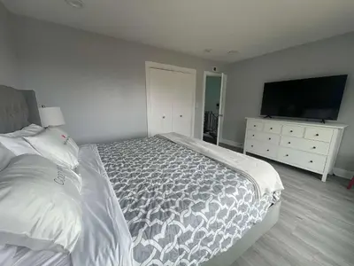 a bedroom with a bed and a dresser with a television at 5 Bedroom House with fabulous mountain views in Hacienda Heights