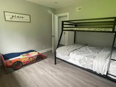 a bedroom with a bunk bed and a toy car on the floor at 5 Bedroom House with fabulous mountain views in Hacienda Heights