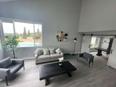 a living room with a couch and a table and a piano at 5 Bedroom House with fabulous mountain views in Hacienda Heights
