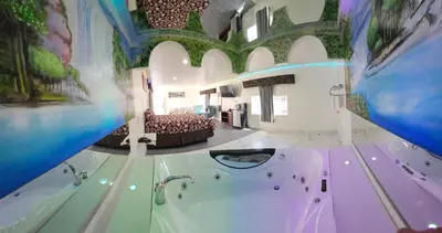 a large room with a tub with a bed in it at Dream Inn in Inglewood