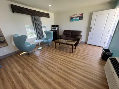 a living room with a couch and chairs and a table at Dream Inn in Inglewood