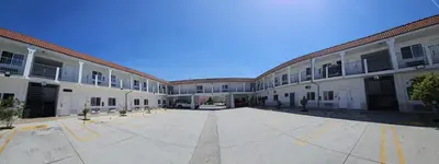 an empty courtyard of a large building with a lot of windows at Dream Inn in Inglewood