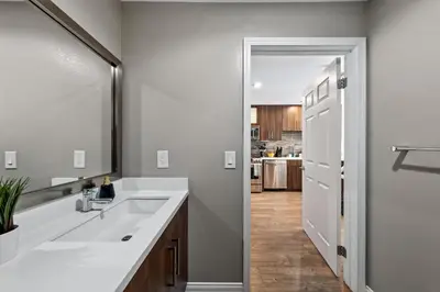 a bathroom with a sink and a mirror at Ocean Views - Rooftop Pool 2BR Santa Monica in Los Angeles