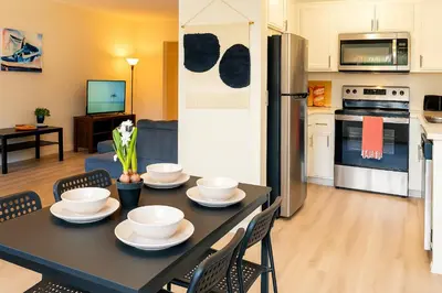 a kitchen with a table with bowls and plates on it at Redondo Huge 1Bedroom,3 Queens, close to Beach Sleeps 7 in Redondo Beach