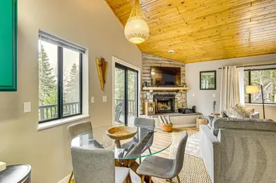 a living room with a table and chairs and a fireplace at 2 Mi to Lake Arrowhead Treetop Retreat with Deck in Lake Arrowhead
