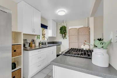 a kitchen with white cabinets and a counter top at Beautifully Remodeled 2bed1bath Apartment Top Location 15 min to Beach in Los Angeles