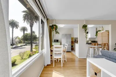 a kitchen and living room with a large window at Beautifully Remodeled 2bed1bath Apartment Top Location 15 min to Beach in Los Angeles