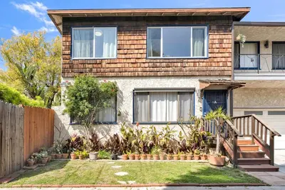 a house with a wooden fence in front of it at Beautifully Remodeled 2bed1bath Apartment Top Location 15 min to Beach in Los Angeles