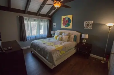 a bedroom with a bed and a ceiling fan at Radiator Springs by Funtierland Vacation Rentals in Anaheim