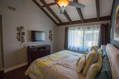 a bedroom with a bed and a ceiling fan at Radiator Springs by Funtierland Vacation Rentals in Anaheim