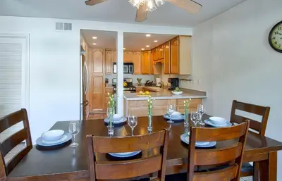 a kitchen and dining room with a table and chairs at Tron by Funtierland Vacation Rentals in Anaheim