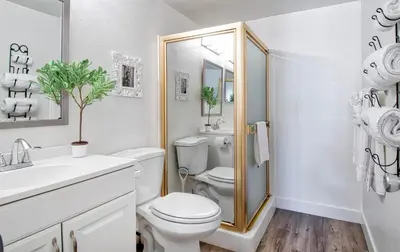 a white bathroom with a toilet and a sink at Tron by Funtierland Vacation Rentals in Anaheim