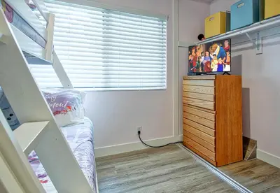 a bedroom with a bunk bed and a tv on a dresser at Tron by Funtierland Vacation Rentals in Anaheim