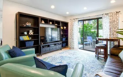 a living room with a couch and a table at Tron by Funtierland Vacation Rentals in Anaheim