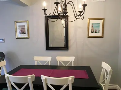 a dining room with a black table and white chairs at Arendelle by Funtierland Vacation Rentals in Anaheim