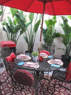 a black table with chairs and an umbrella at Pixie Hollow by Funtierland Vacation Rentals in Anaheim