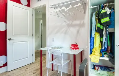 a small room with a table and a closet at New Suite Escapes 5 by Funtierland Vacation Rentals in Anaheim