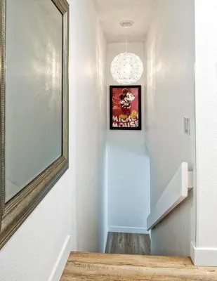 a hallway with a mirror and a picture on the wall at New Suite Escapes 6 by Funtierland Vacation Rentals in Anaheim