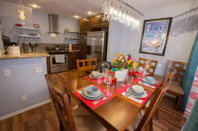 a kitchen and dining room with a table and chairs at Bedknobs and Broomsticks by Funtierland Vacation Rentals in Anaheim