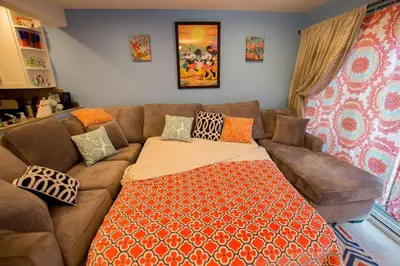 a living room with a couch and a bed at Under the Sea by Funtierland Vacation Rentals in Anaheim