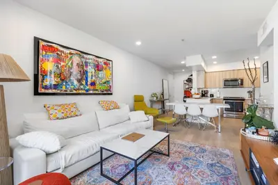 a living room with a white couch and a painting on the wall at Huge Stylish Apartment Santa Mon in Los Angeles