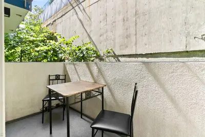 a small table and two chairs on a balcony at Spacious and Bright West Hollywood Pool & Gym in Los Angeles