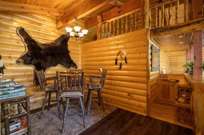 a dining room in a cabin with a bear head on the wall at Ultimate Lakeview Lodge and ON THE LAKE! with a Hot-Tub! in Big Bear Lake