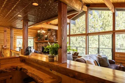 a large living room with a large wooden counter at Ultimate Lakeview Lodge and ON THE LAKE! with a Hot-Tub! in Big Bear Lake
