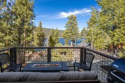 a patio with a couch and chairs on a balcony at Ultimate Lakeview Lodge and ON THE LAKE! with a Hot-Tub! in Big Bear Lake