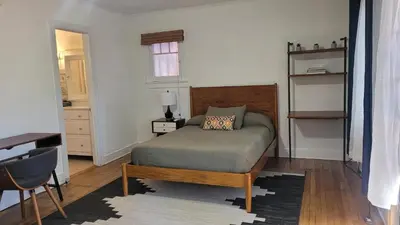a bedroom with a bed and a table and a desk at Charming Studio Four with Private Patio in Los Angeles