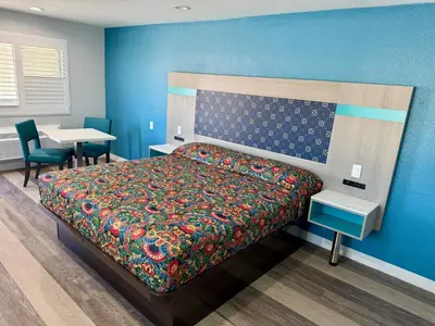 a bedroom with a bed and a table and a desk at Royale Inn \u8001\u723a\u5ba2\u68e7 - San Gabriel, Los Angeles in Rosemead