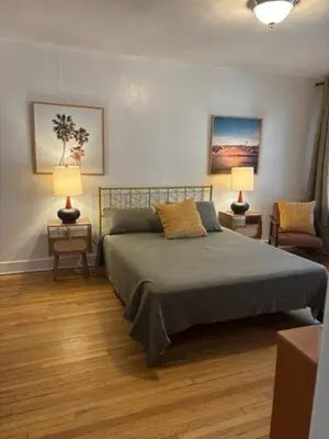 a bedroom with a bed with two tables and two lamps at Cozy Apartment Two in Hollywood! in Los Angeles