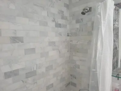 a bathroom with a shower with white tiles at Cozy Apartment Two in Hollywood! in Los Angeles