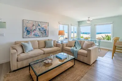 a living room with two couches and a table at Carpinteria Dreamin by Paradise Retreats in Carpinteria