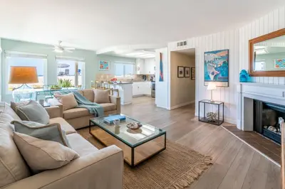 a living room with a couch and a fireplace at Carpinteria Dreamin by Paradise Retreats in Carpinteria