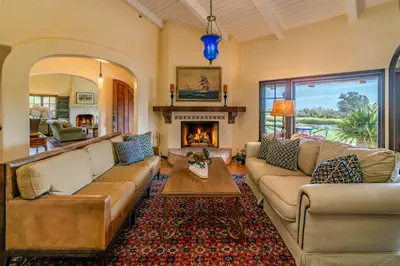 a living room with a couch and a fireplace at Casa Tranquility by Paradise Retreats in Carpinteria