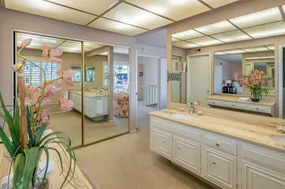 a bathroom with a sink and a large mirror at Keys Retreat by Paradise Retreats in Ventura