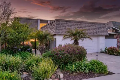 a house with a garage and palm trees at Keys Retreat by Paradise Retreats in Ventura
