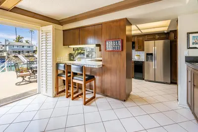 an open kitchen with a view of a patio at Keys Retreat by Paradise Retreats in Ventura