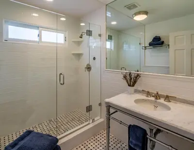 a bathroom with a glass shower and a sink at Ocean Breeze Abode and Bungalow by Paradise Retreats in Summerland