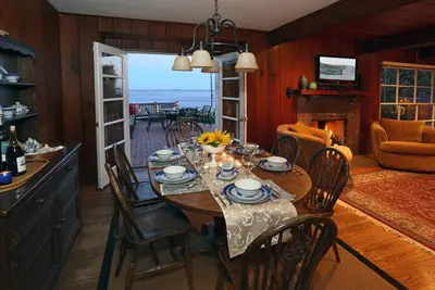 a dining room with a table with chairs and a fireplace at Rincon Retreat by Paradise Retreats in Carpinteria