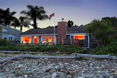 a house with an american flag in front of it at Rincon Retreat by Paradise Retreats in Carpinteria