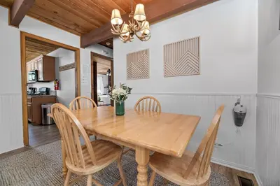 a dining room with a wooden table and chairs at Modern Lake Cabin for Family, Friends and Pets! in Big Bear Lake