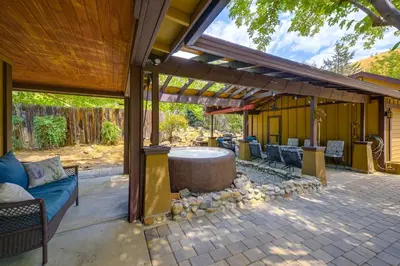 a patio with a table and chairs under a pergola at Walk to Riverfront Beach Kernville Escape in Kernville