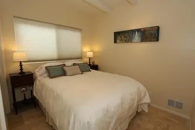 a bedroom with a white bed with two pillows at Seacliff Beach House by Paradise Retreats in Ventura