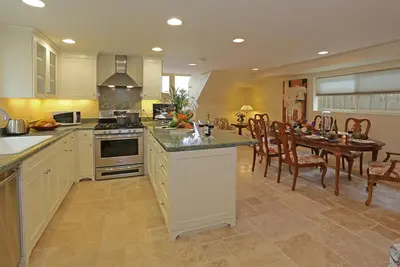 a large kitchen with a table and a dining room at Seacliff Beach House by Paradise Retreats in Ventura