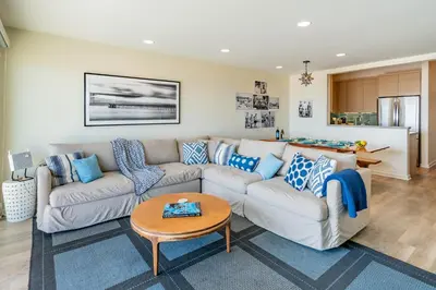 a living room with a couch and a table at Seahorse Cottage by Paradise Retreats in Carpinteria